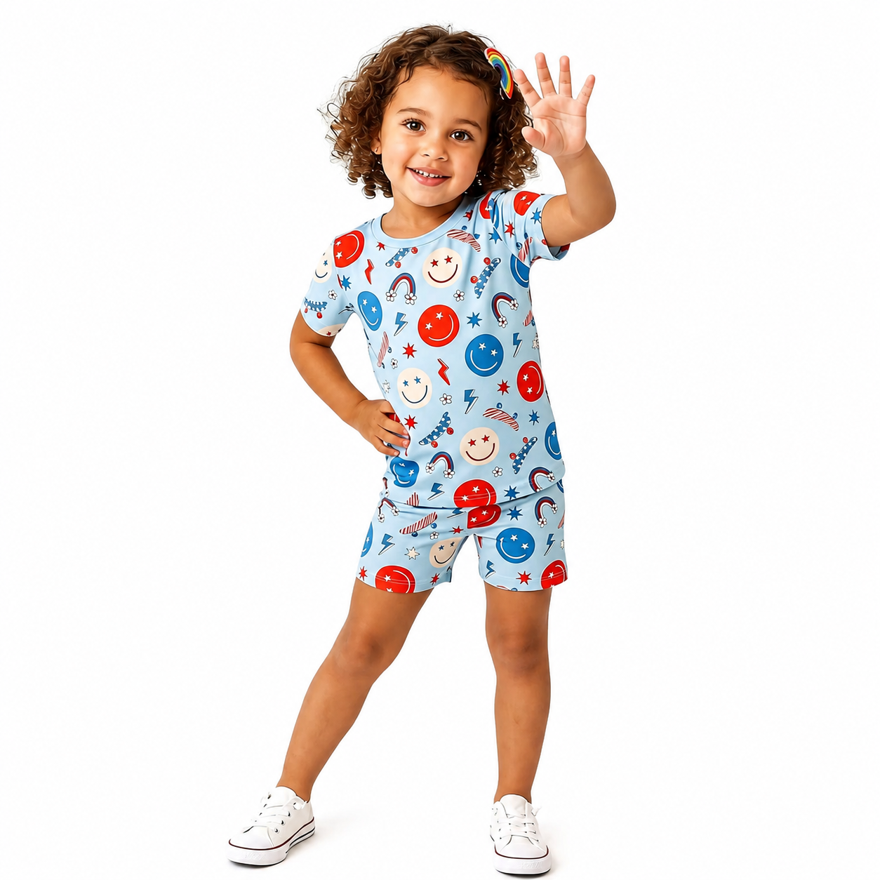 Child wearing a colorful pajama set with cartoon designs on a white background