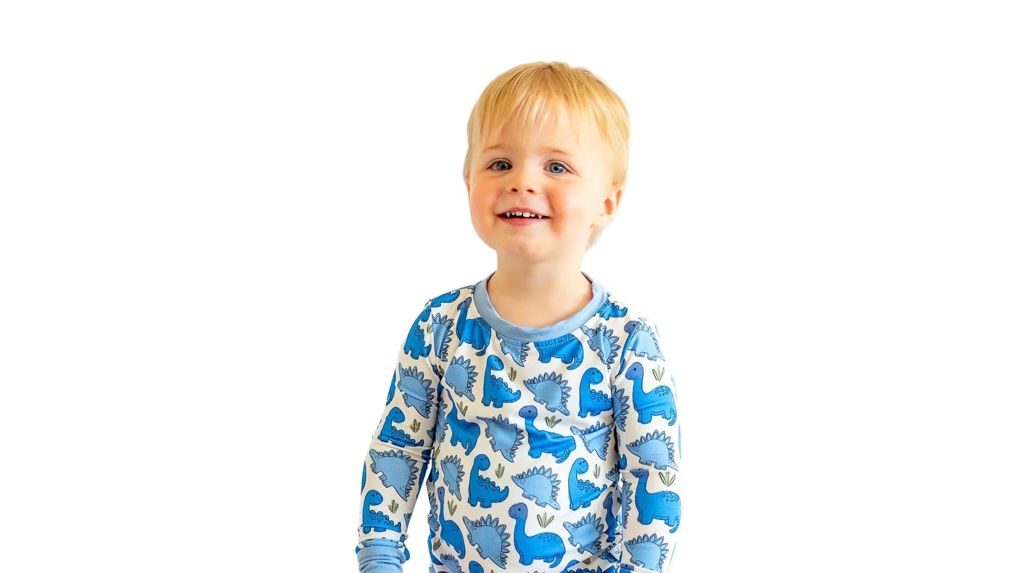 Child wearing a blue dinosaur pajama set on a white background