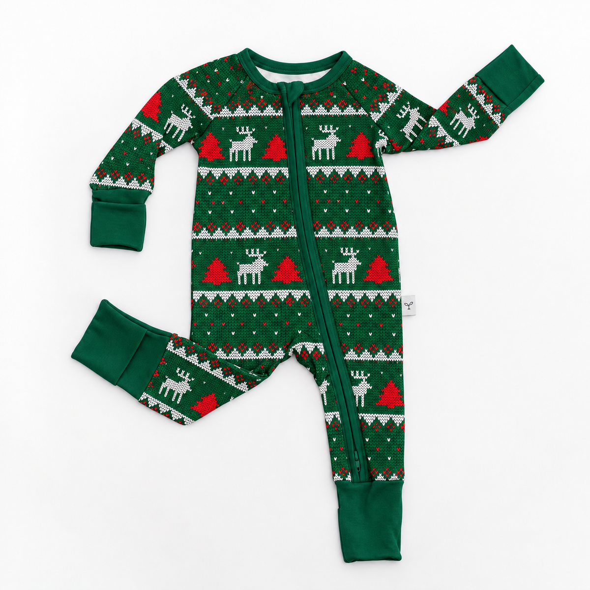 A baby's long-sleeve zip-up footed sleeper in a festive Christmas knit fair isla pattern of green, white, and red, laid flat on a white background.