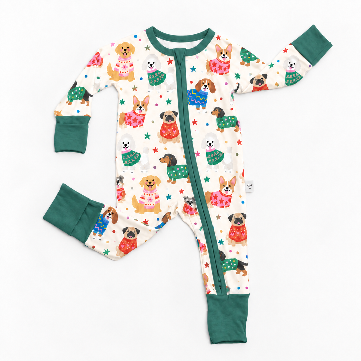 A baby long-sleeve footless one-piece pajama with a front zipper, featuring an all-over print of cute dog illustrations in holiday sweaters and stars, with solid dark green cuffs and hem.