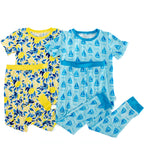 Two children's short-sleeve pajama sets laid flat on a white background. The left set is yellow with blue leaf and lemon prints and a yellow waistband.