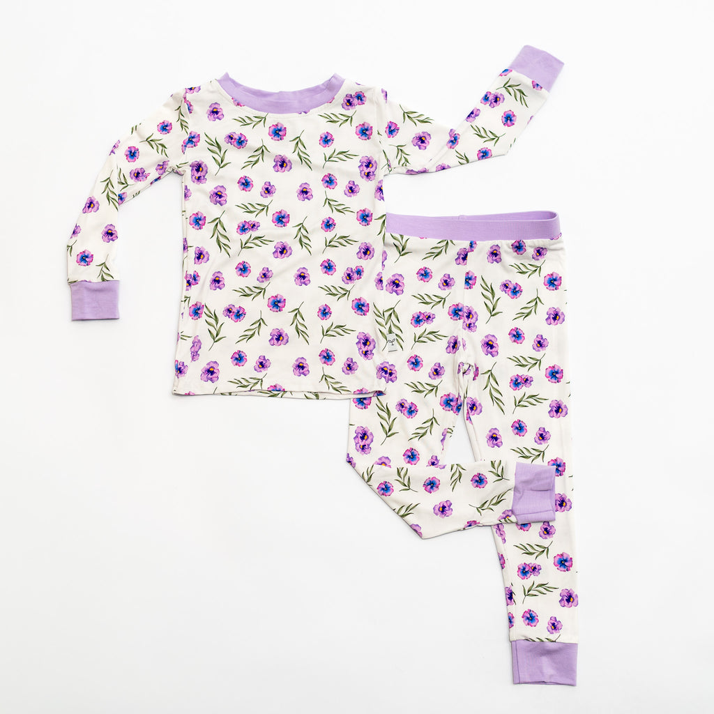 Children's pajama set with floral pattern on a white background.