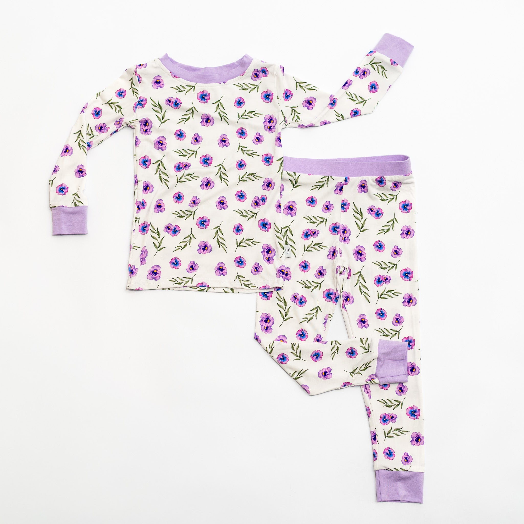 Children's pajama set with floral pattern on a white background.