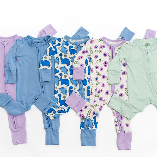 Set of colorful baby bamboo rompers on a white background.