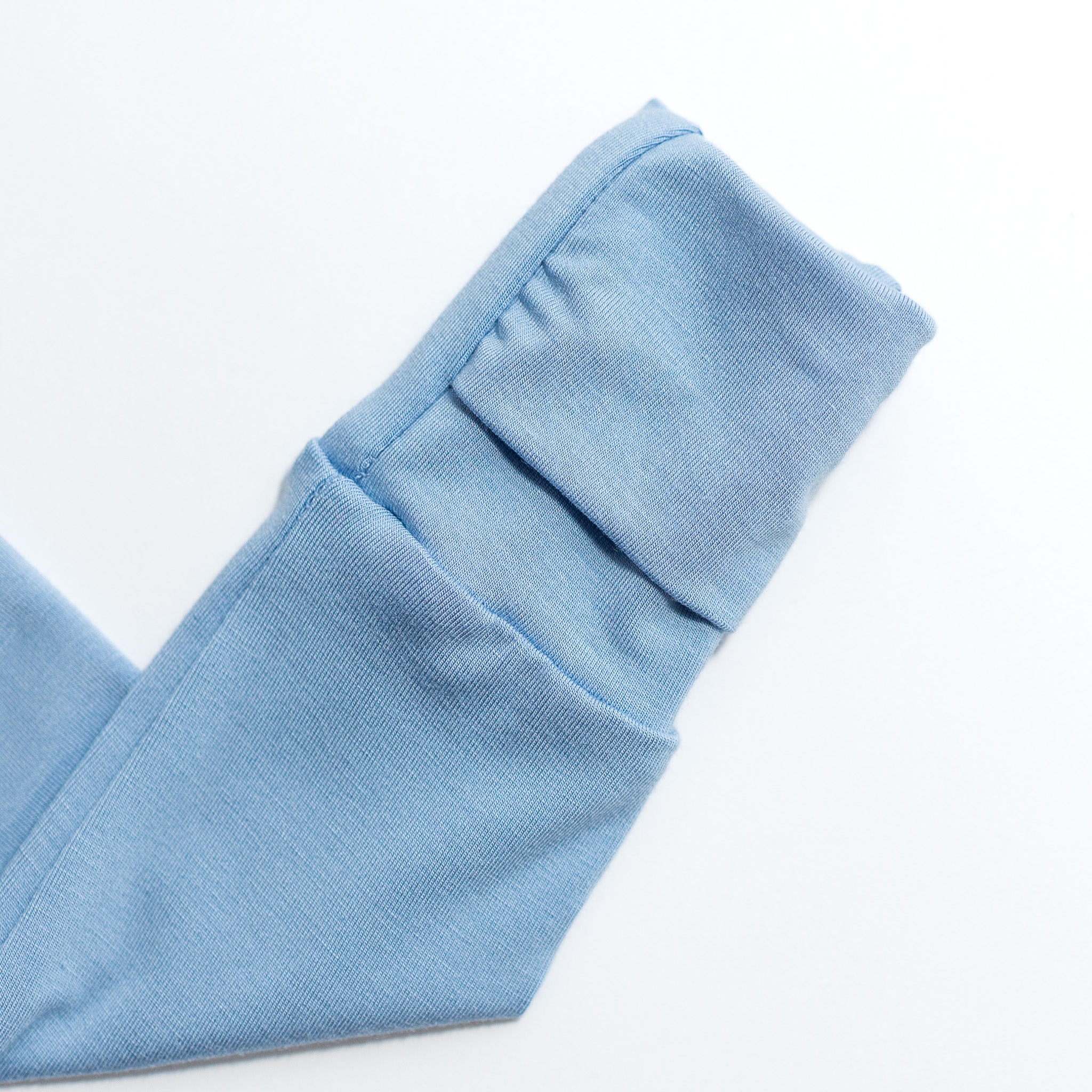 Close-up of light blue bamboo fabric with a white background.