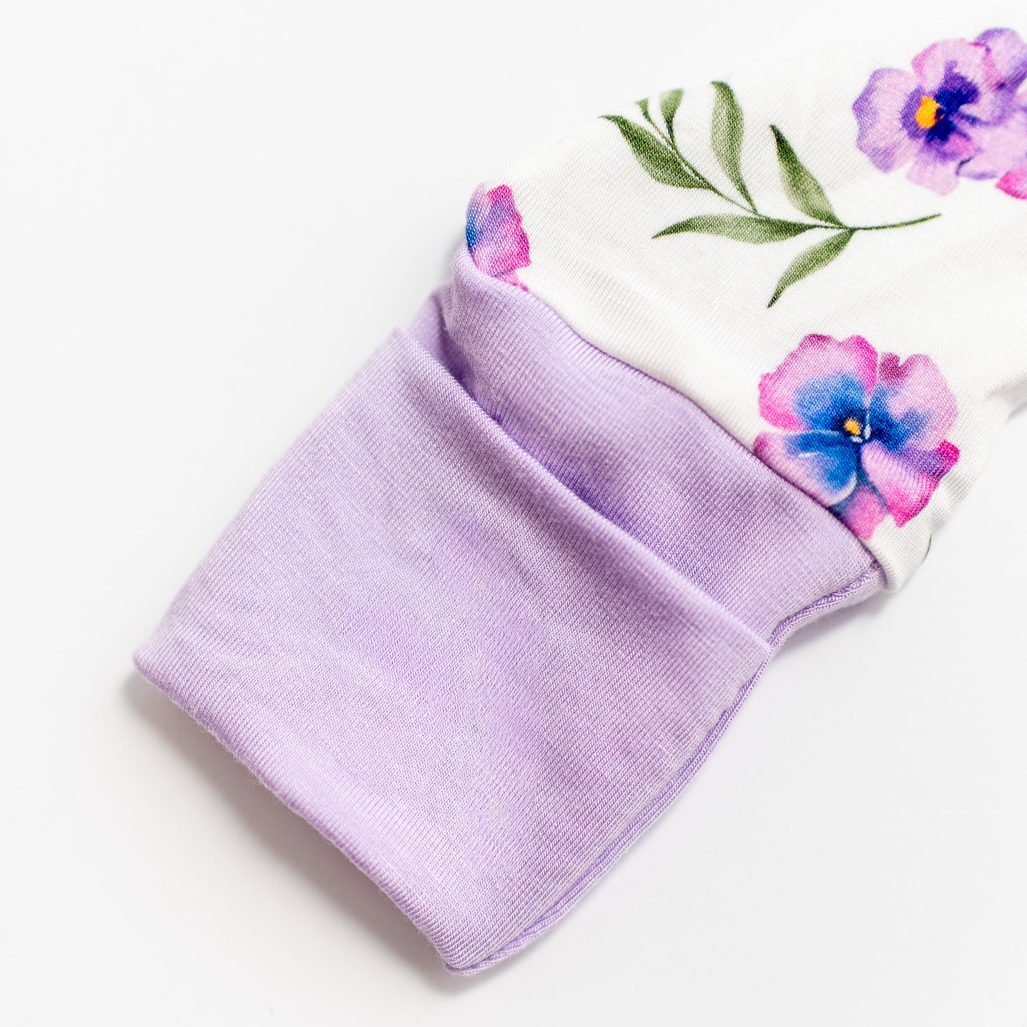 Purple bamboo fabric with floral designs on a white background.