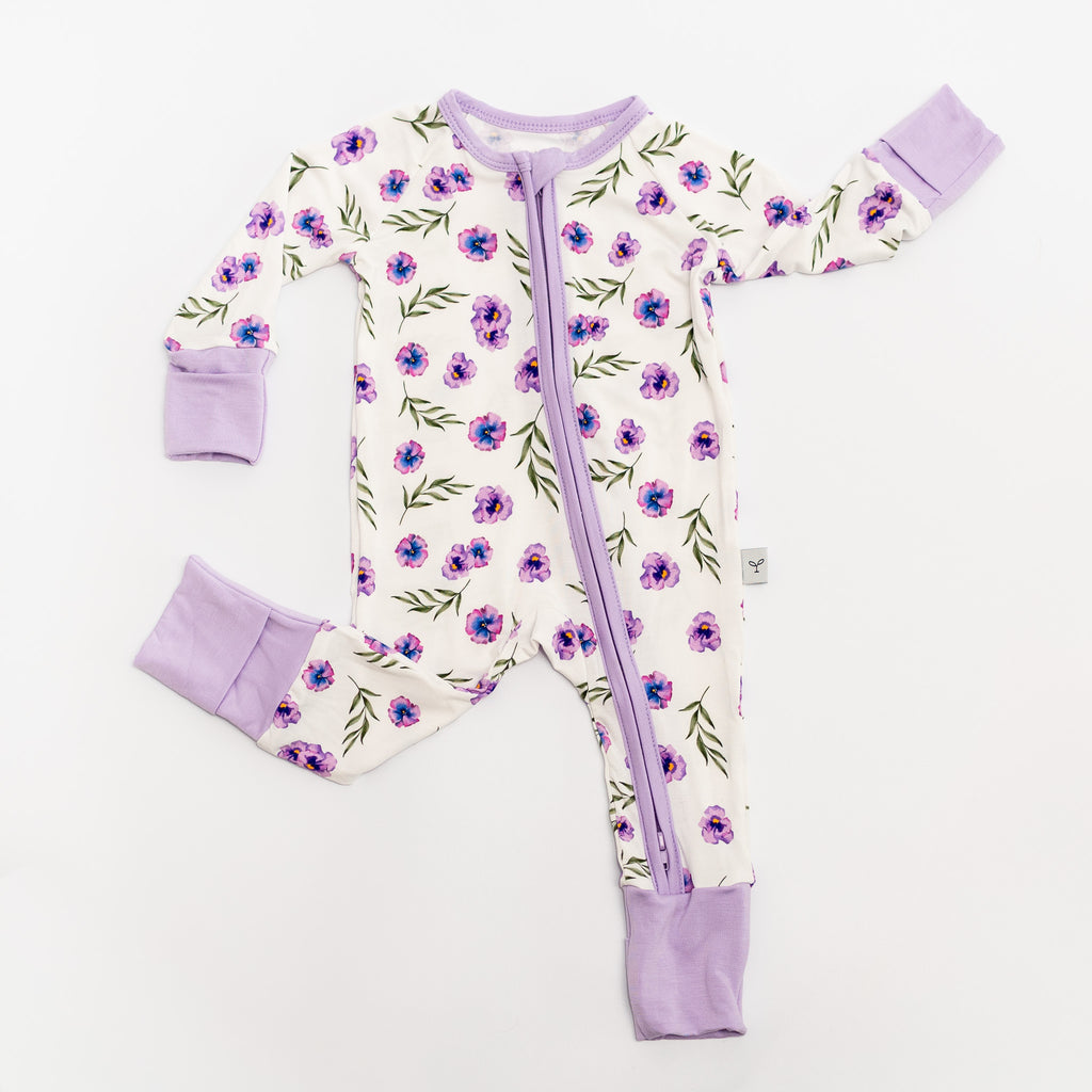 Baby romper bamboo with floral pattern and purple accents on a white.