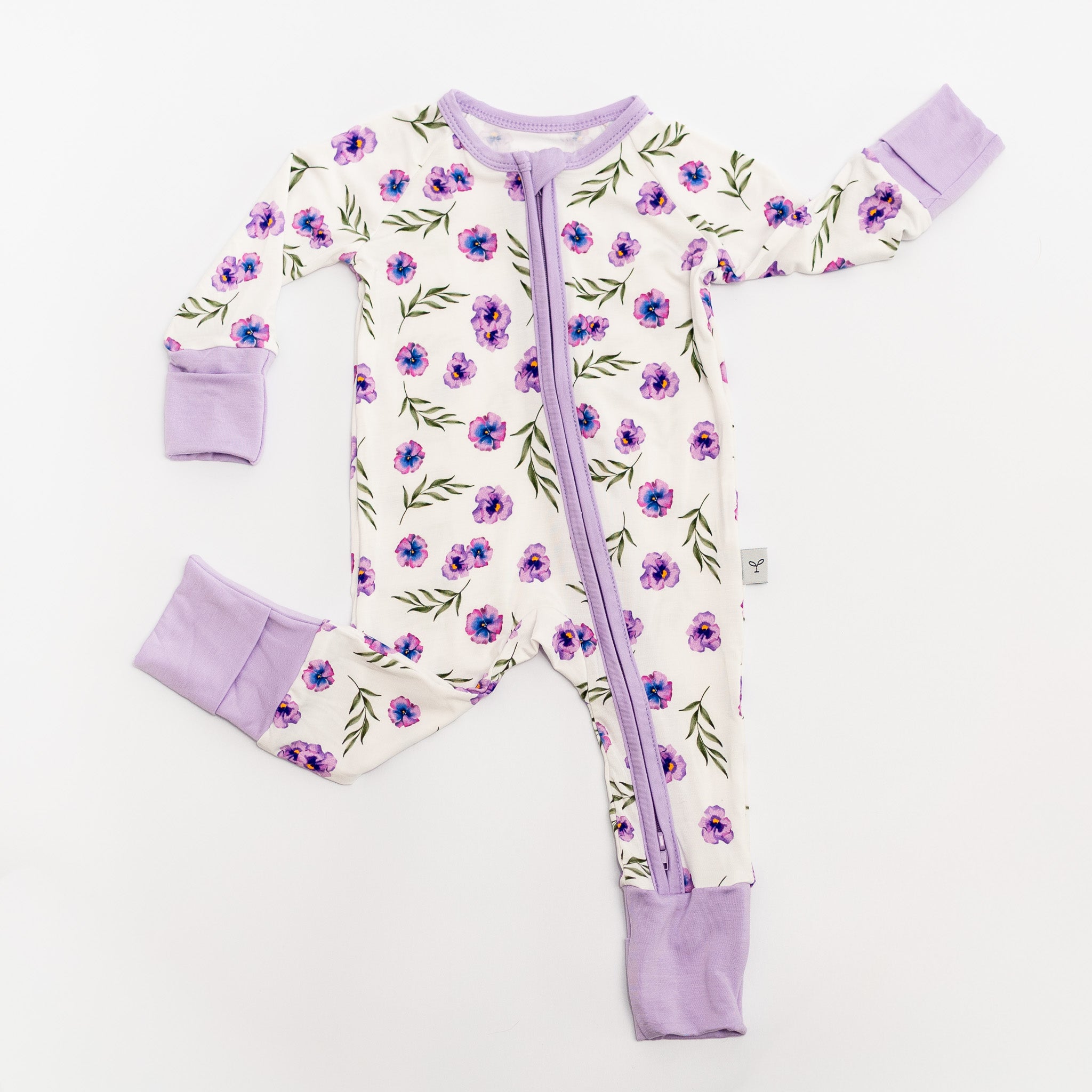 Baby romper bamboo with floral pattern and purple accents on a white.