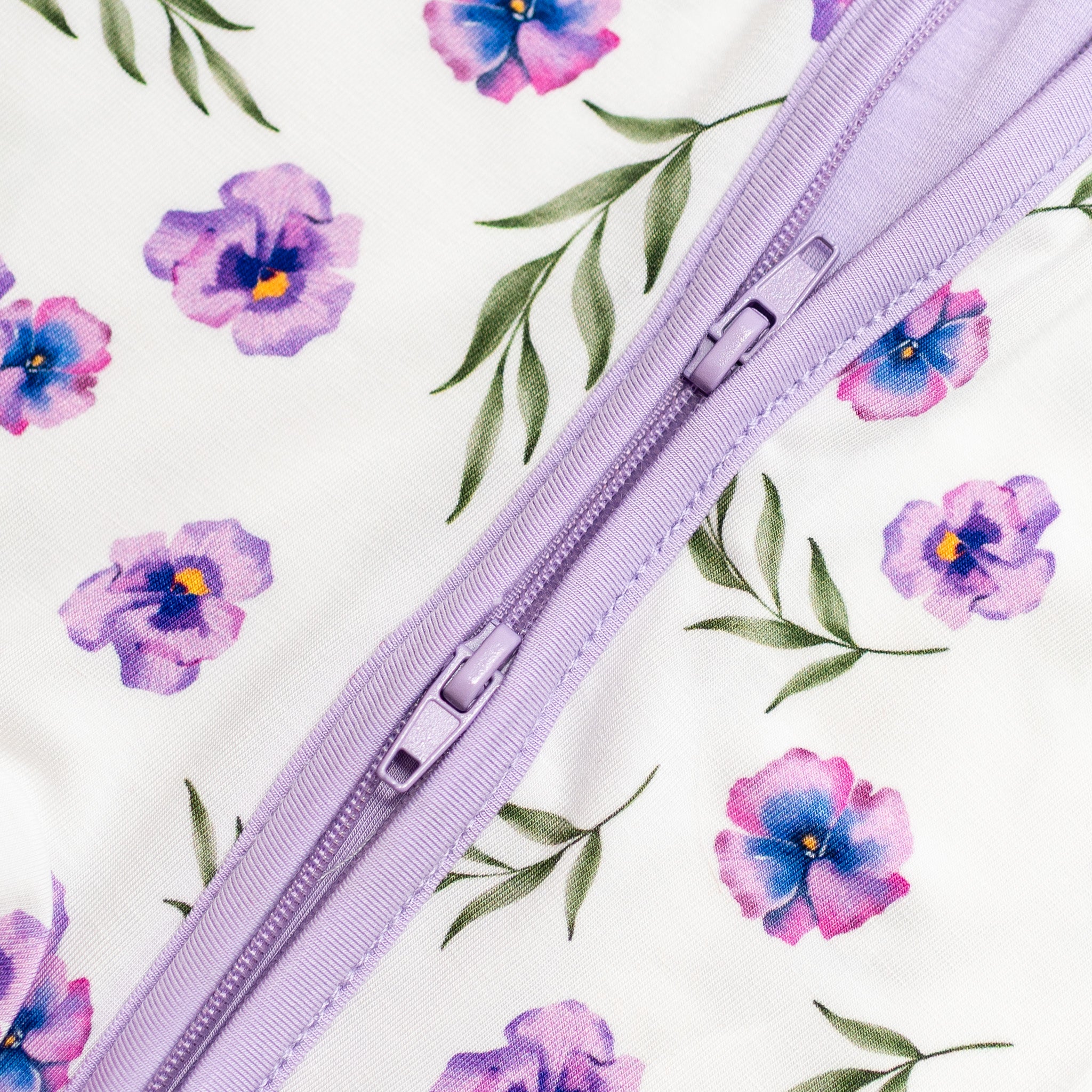Purple zipper floral bamboo fabric with purple flowers and green leaves.