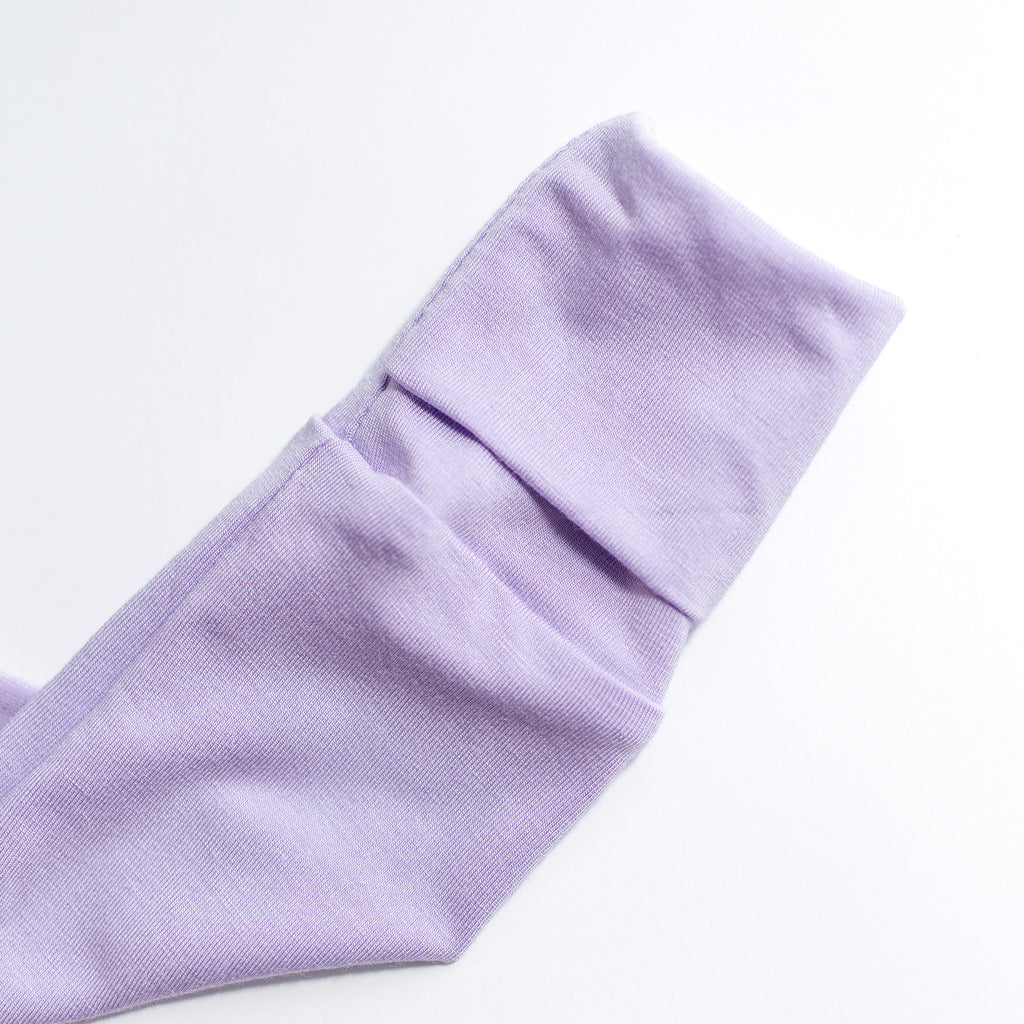Close-up of a folded lavender pajama cuff on a white background.
