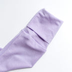 Close-up of a folded lavender pajama cuff on a white background.