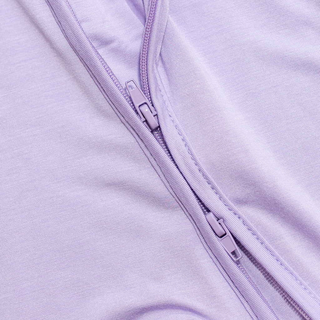 Close-up of a purple zipper purple bamboo pajama fabric.