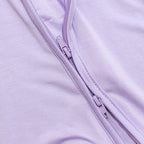 Close-up of a purple zipper purple bamboo pajama fabric.