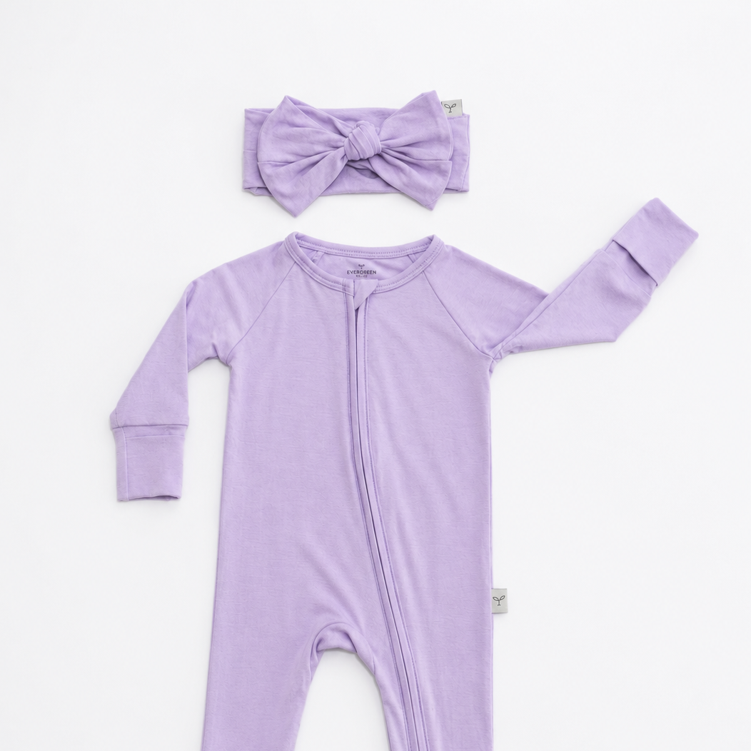 Purple baby onesie with matching headband on a white background